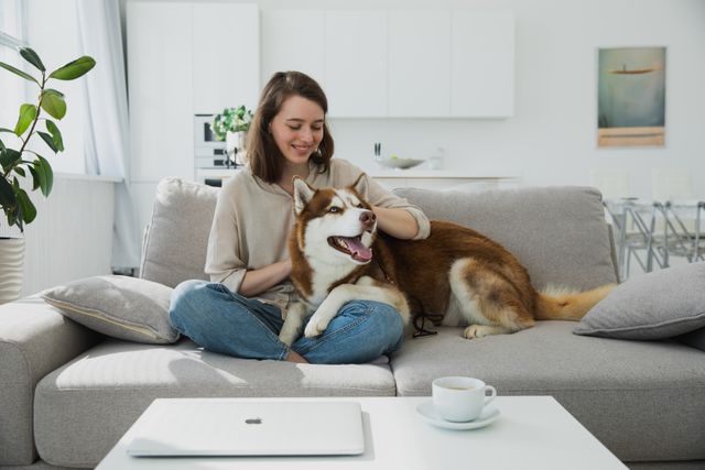 a tenant and their dog sitting on a couch